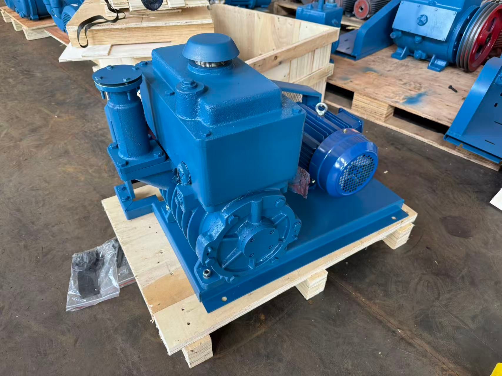 2X Series belt-driven vacuum pump — motor side view on wooden pallet