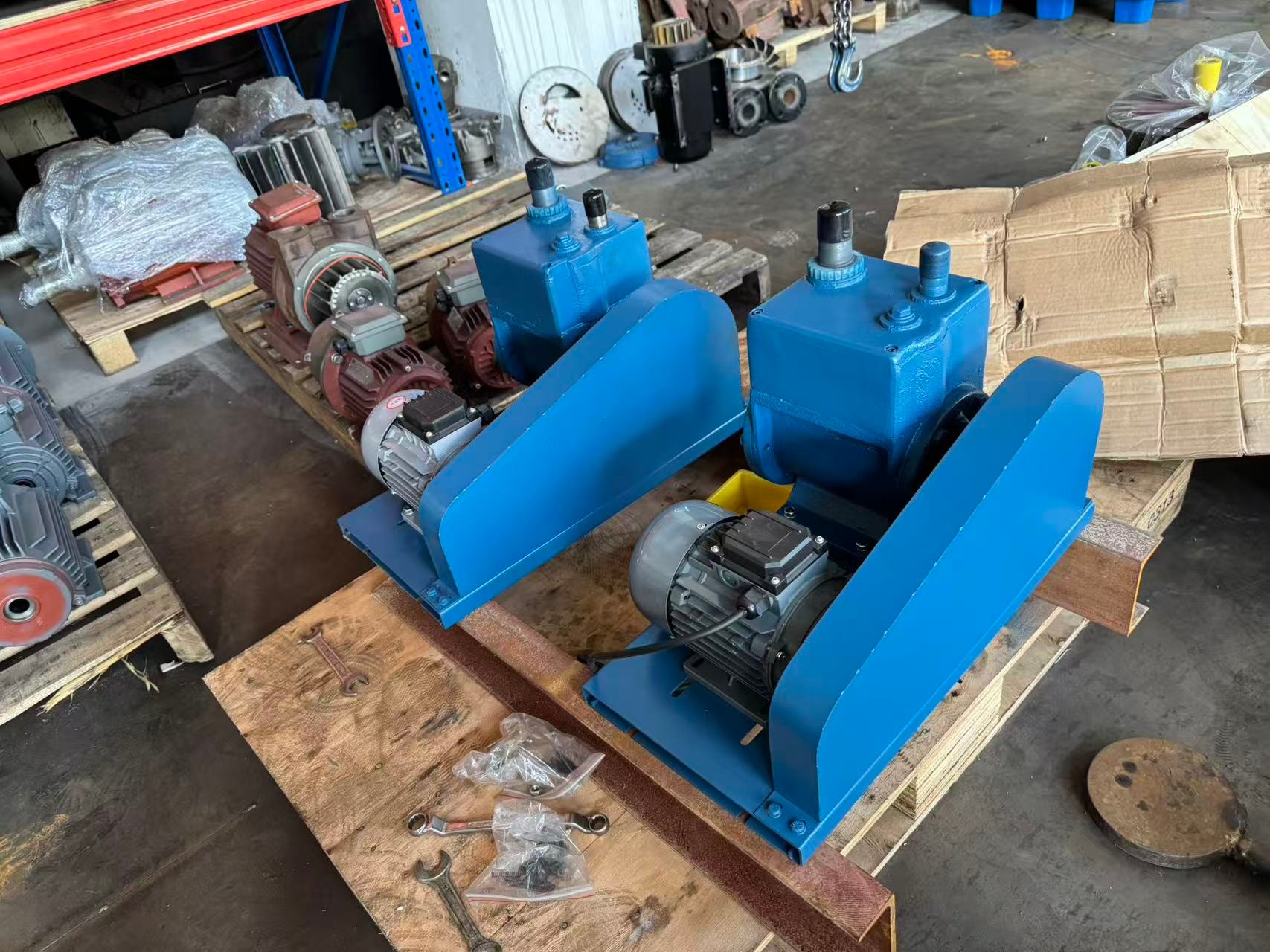 2X Series belt-driven vacuum pumps — pair with belt guards, factory floor